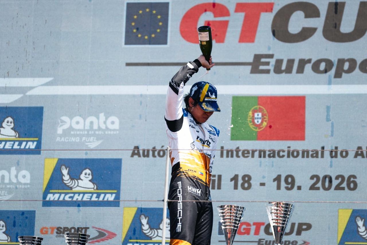 Angelo sprays champagne on the GT Cup Europe Portimão podium, 19 April 2026